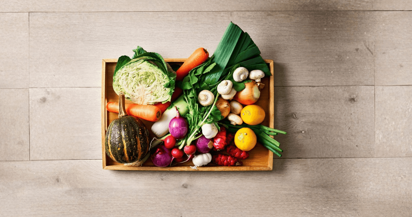 A crate of fresh vegetables in various colours and textures