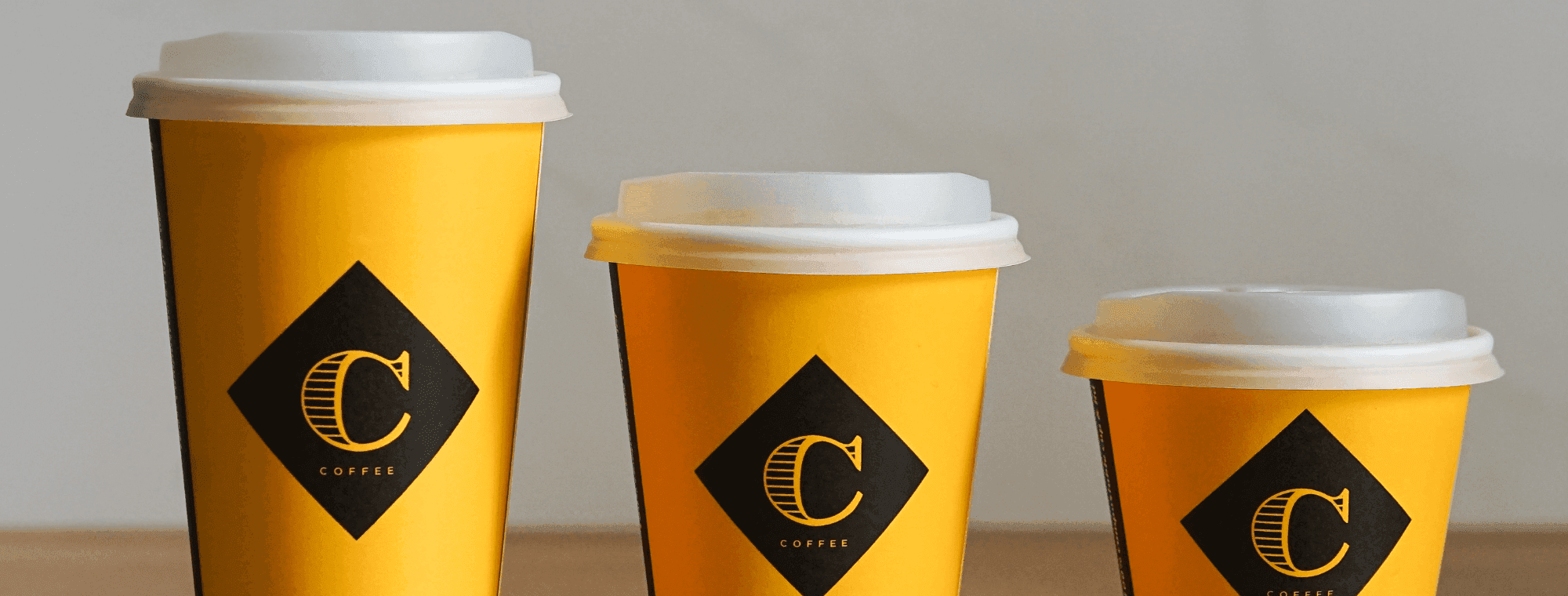 Left to right: large, medium and small takeaway coffee cups with Columbus Coffee branding